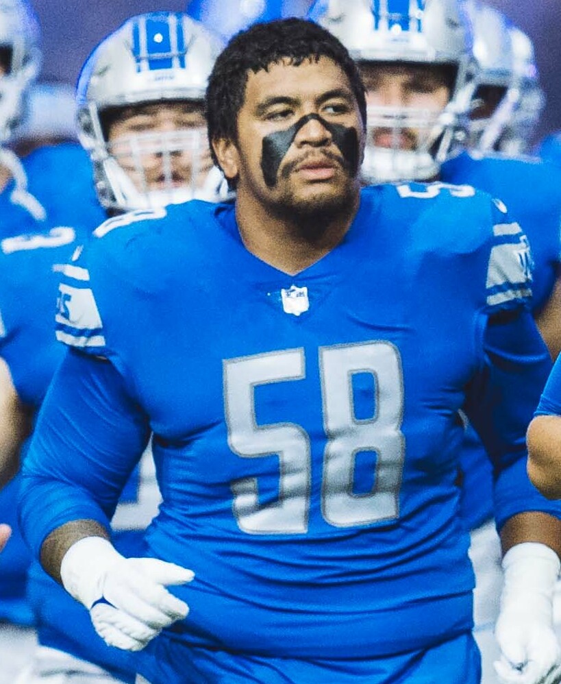 Penei Sewell in a Detroit Lions uniform entering the field in 2022.
